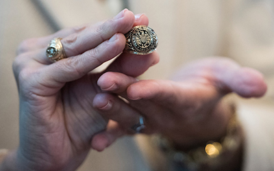 Hands holding an Aggie ring