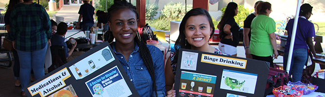 SSHP members holding informational signs at a health fair